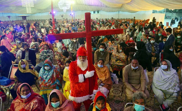 Pakistani large number Christian community devotees take part in a special service lighting the candles during ceremony regarding the celebrations of Christmas at Bahar Colony in Lahore on December 23, 2020. (Photo by Rana Sajid Hussain/Pacific Press Agency/Rex Features/Shutterstock)