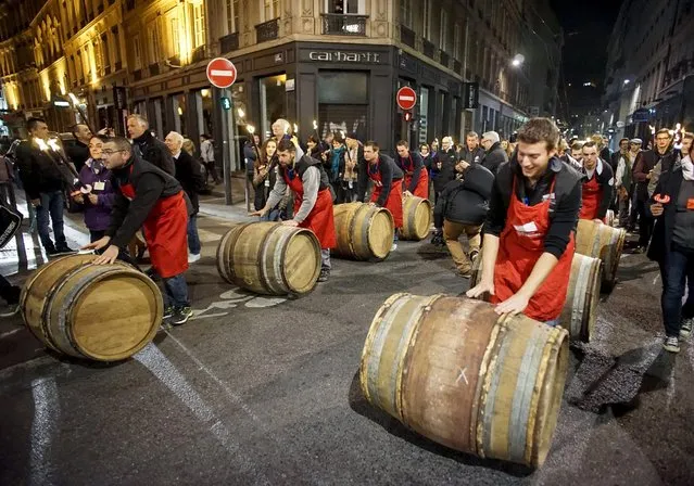 Men roll barrels of Beaujolais Nouveau wine for the official launch of the 2015 vintage in the center of Lyon early November 19, 2015. (Photo by Robert Pratta/Reuters)