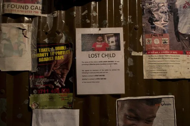A poster of a lost child is attached to an iron sheet wall in a police station near Korogocho in Nairobi, Kenya, October 30, 2015. (Photo by Siegfried Modola/Reuters)