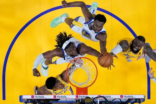 Golden State Warriors forwards Kevon Looney and Andrew Wiggins (22) and Los Angeles Lakers forwards Rui Hachimura, lower left, and LeBron James, right, compete for possession of the ball during the second half of Game 5 of an NBA basketball second-round playoff series, Wednesday, May 10, 2023, in San Francisco. (Photo by Godofredo A. Vásquez/AP Photo)