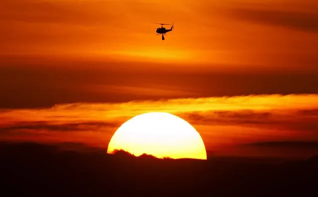 A helicopter transports sandbags to a flooded area near Fischbeck, Germany, on June 10, 2013. Weeks of heavy rain this spring have sent the Elbe, the Danube and other rivers such as the Vltava and the Saale overflowing their banks, causing extensive damage in central and southern Germany, the Czech Republic, Austria, Slovakia and Hungary. (Photo by Jens Meyer/Associated Press)