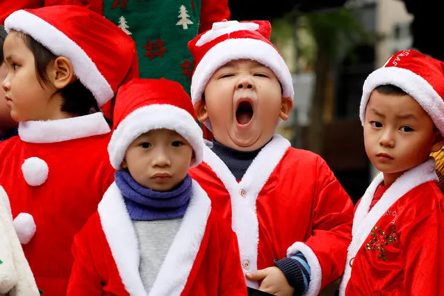 Children wearing Santa Claus outfits visit a church in Hanoi, Vietnam, 21 December 2020. Although Christmas is not an official holiday in Vietnam, it has seen an increase in popularity with festive activities held during Christmas period in the nation. (Photo by Luong Thai Linh/EPA/EFE)