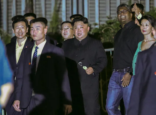 North Korea leader Kim Jong Un, center, is escorted by his security delegation as he visits Marina Bay in Singapore, Monday, June 11, 2018, ahead of Kim's summit with U.S. President Donald Trump. (Photo by Yong Teck Lim/AP Photo)