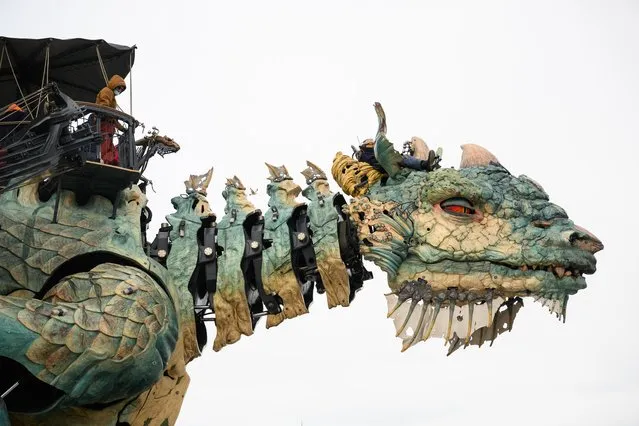 The Dragon of Calais (La Compagnie du Dragon) carries members of the public along the renovated seafront on March 11, 2022 in Calais, France. The mechanised dragon breathes fire and steam, and is controlled by a team of puppeteers both in the creature and on the surrounding path. (Photo by Leon Neal/Getty Images)