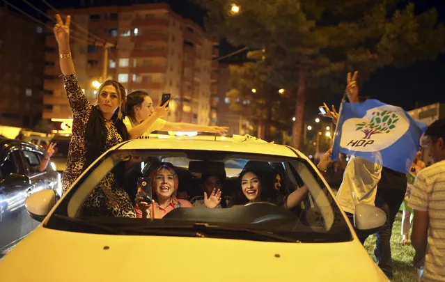 Supporters of the pro-Kurdish Peoples' Democratic Party, or HDP, celebrate in the mainly-Kurdish city of Diyarbakir, southeastern Turkey, Sunday, June 24, 2018. (Photo by Emre Tazegul/AP Photo)
