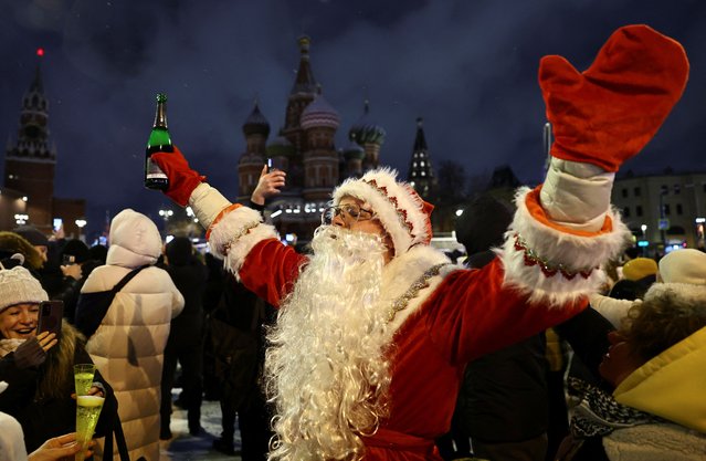 A man dressed as Ded Moroz, the Russian equivalent of Santa Claus, reacts during New Year celebrations near the Spasskaya tower of the Kremlin and St. Basil's Cathedral in central Moscow, Russia, on January 1, 2025. (Photo by Evgenia Novozhenina/Reuters)