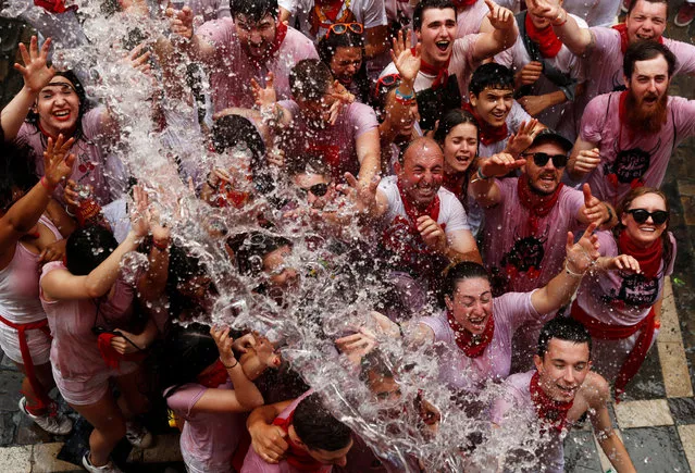 Revellers react after being splashed with water during the opening of the San Fermin festival in Pamplona, Spain on July 6, 2018. (Photo by Susana Vera/Reuters)