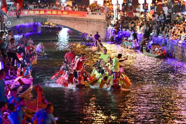 A nighttime dragon boat race is held to celebrate the Dragon Boat Festival in Sanxi Village of Changle District, Fuzhou, capital of southeast China's Fujian Province on June 20, 2023. The nighttime dragon boat race native to Sanxi Village is a tradition with a history spanning over 600 years. Around the Chinese Dragon Boat Festival, the villagers of Sanxi eagerly participate in this race as night falls. The event carries deep cultural significance and reserves as a means of prayer for bountiful harvests and auspicious life. (Photo by Xinhua News Agency/Rex Features/Shutterstock)