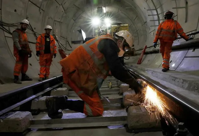 Workers lay railway track in a tunnel of the Crossrail project in Stepney, east London, Britain, November 16, 2016. Crossrail train project runs from west to east London through the heart of the capital. There’s light at the end of the tunnel for Londoners patiently waiting for the opening of the keenly anticipated Elizabeth line, with the first trains due to run in May 2017. When fully completed in 2019, the high-frequency service will connect towns in Berkshire and Buckinghamshire to Essex and south-east London, via the centre of the capital. The new service is designed to ease pressure on the existing Underground network, particularly the busy Central and District lines, and the Jubilee link to Heathrow Airport (it will take 20min off the journey time from central London). The mega-expensive project has caused heavy disruption in central London, particularly around Tottenham Court Road and Oxford Street. While the construction project is officially known as Crossrail, the line itself has been officially named after Queen Elizabeth II, who attended a special ceremony in February 2016. The Elizabeth is actually the second line to be dedicated to her majesty – the Jubilee line was named after the Queen’s Silver Jubilee, which commemorated 25 years on the throne in 1977. (Photo by Stefan Wermuth/Reuters)