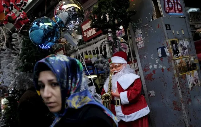 A woman walks past by a store selling New Year and Christmas ornaments in Istanbul, Turkey, December 22, 2015. (Photo by Murad Sezer/Reuters)