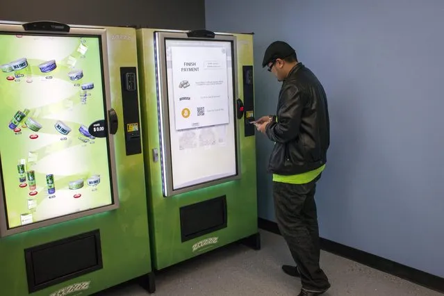 Lynyrd Puyat uses a ZaZZZ vending machine to purchase one gram of the Girl Scout Cookies strain of marijuana for $15 at Seattle Caregivers, a medical marijuana dispensary, in Seattle, Washington February 3, 2015. (Photo by David Ryder/Reuters)