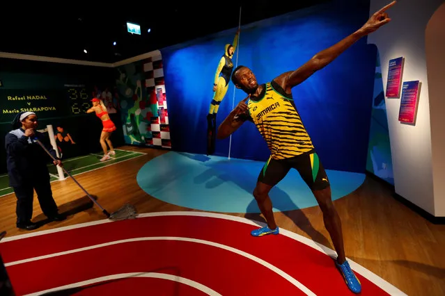 A cleaning lady mops the floor next to a wax figure of Jamaican Olympic gold medallist Usain Bolt at a new Madame Tussauds museum in Istanbul, Turkey November 22, 2016. (Photo by Murad Sezer/Reuters)