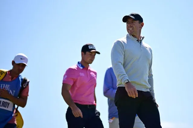 Northern Ireland's Rory McIlroy (R) and Norway's Viktor Hovland (C) leave the 12th tee during a practice round for 151st British Open Golf Championship at Royal Liverpool Golf Course in Hoylake, north west England on July 19, 2023. The Royal Liverpool Golf Course will host The 151st Open from July 20 to 23, 2023. (Photo by Ben Stansall/AFP Photo)