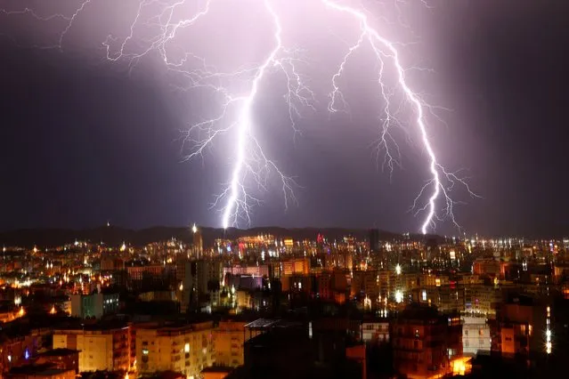Lightnings flash over Tirana, Albania on December 17, 2022. (Photo by Florion Goga/Reuters)