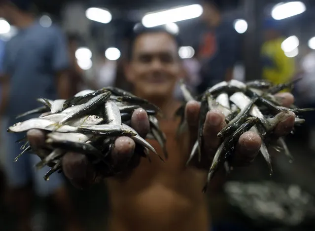 A Filipino vendor displays tiny fish as he sells them at a market in Paranaque city, south of Manila, Philippines, Wednesday, January 20, 2016. According to a new report released by the World Economic Forum (WEF) and the Ellen MacArthur Foundation, oceans are expected to contain more plastics than fish (by weight) by 2050. The 46th Annual Meeting of the World Economic Forum is taking place in Davos, Switzerland with a theme “Mastering the Fourth Industrial Revolution”. (Photo by Francis R. Malasig/EPA)