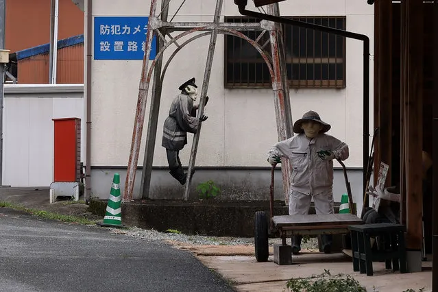 A handmade human-sized scarecrow dressed up as a fireman climbs the ladder to illustrate the old Japanese countryside life in the village of “Kakasi No Sato” on September 20, 2023 in Yasutomi, Japan. (Photo by Buddhika Weerasinghe/Getty Images)