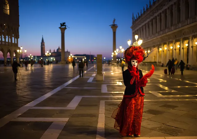 A woman wearing a carnival costume poses in Piazza San Marco on February 06, 2016 in Venice, Italy. The 2016 Carnival of Venice will run from January 23 to February 9 and includes a program of gala dinners, parades, dances, masked balls and music events.  (Photo by Marco Secchi/Getty Images)