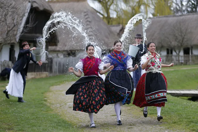 Women run as men throw water at them as part of traditional Easter celebrations, during a media presentation in Szenna, Hungary, April 3, 2015. Locals celebrate Easter with the traditional “watering of the girls”, a fertility ritual rooted in Hungarian tribes' pre-Christian past, going as far back as the second century after Christ. (Photo by Laszlo Balogh/Reuters)