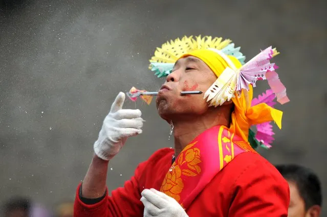 A folk performer has his cheek pierced with a metal rod during a Shehuo festival at the beginning of the Chinese Lunar New Year at a village in Yuncheng, Shanxi province, February 11, 2016. (Photo by Reuters/Stringer)