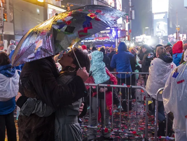 Revelers celebrate and embrace on Times Square in New York, Tuesday, January 1, 2019, as they take part in a New Year's Eve celebration. (Photo by Craig Ruttle/AP Photo)