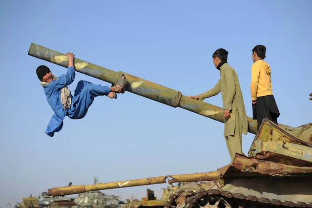 Afghan boys play on a Soviet-era tank in Jalalabad, Afghanistan, 15 February 2016. Soviet troops occupied the country for ten years between 1979 and 1989. (Photo by Ghulamullah Habibi/EPA)