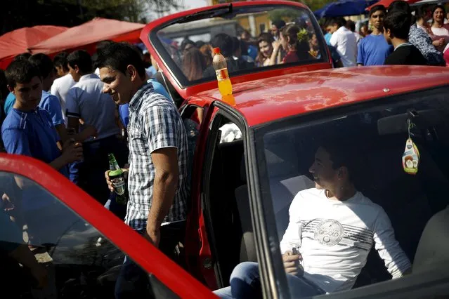 Bulgarian Roma men from the close-knit Kalaidjii clan play music from their car as they attend a so-called “bride fair” in a suburb of the city of Plovdiv April 13, 2015. (Photo by Stoyan Nenov/Reuters)