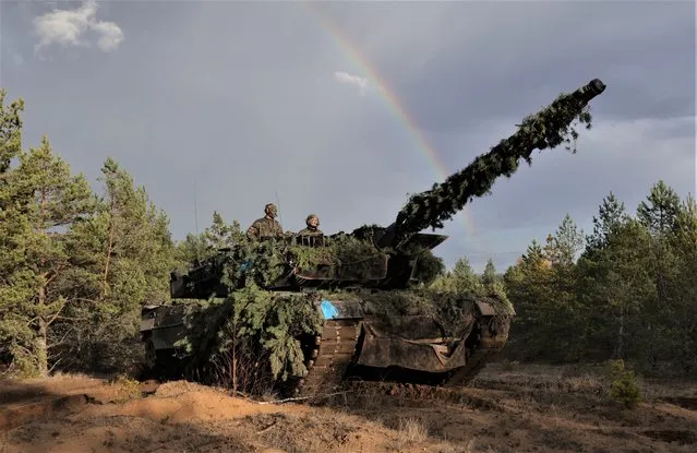 A Leopard 2A6 main battle tank of the Bundeswehr, the German armed forces, stands with a rainbow behind as it participates in the NATO Iron Wolf military exercises on October 26, 2022 in Pabrade, Lithuania. Germany leads a NATO contingent of troops in Lithuania under the Enhanced Forward Presence (eFP) battle group, with troops also from Belgium, the Czech Republic, the Netherlands, Luxembourg and Norway. (Photo by Sean Gallup/Getty Images)