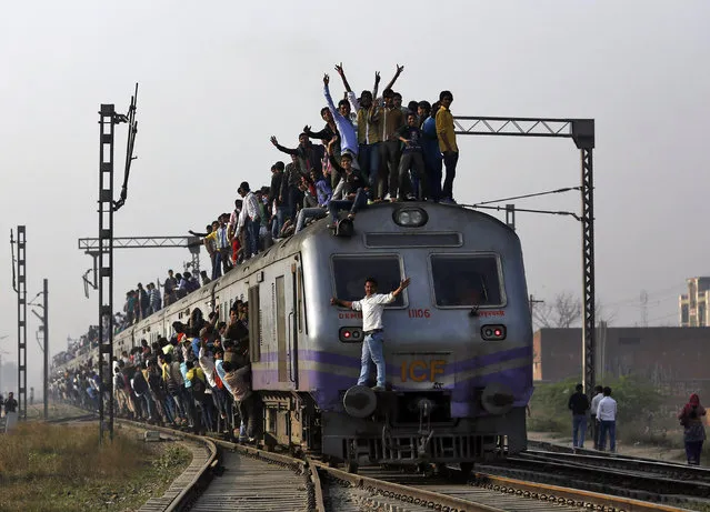 Passengers travel on an overcrowded train on the outskirts of New Delhi, February 26, 2015. (Photo by Ahmad Masood/Reuters)
