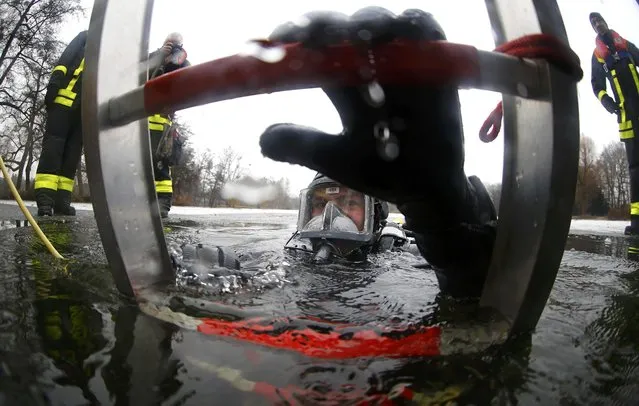 Martin Weitzendoerfer, diver of Frankfurt's firefighter rescue brigade, leaves a frozen lake during a rescue exercise in Frankfurt, Germany, January 24, 2017. (Photo by Kai Pfaffenbach/Reuters)