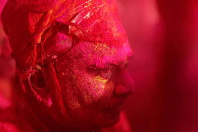 A Hindu devotee takes part in the religious festival of Holi inside a temple in Nandgaon village, in the state of Uttar Pradesh, India, March 16, 2019. (Photo by Adnan Abidi/Reuters)