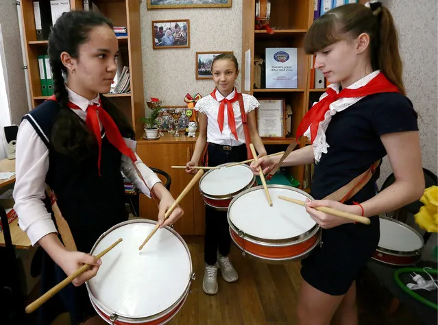 Girls learn playing drums as Semyonov Secondary School in the village of Primorsk in Volgograd Region, Russia on April 17, 2019 revives traditions of the Soviet pioneer youth organisation, its pupils no younger than fifth grade obliged to form detachments, wear red ties, salute and help senior villagers. (Photo by Dmitry Rogulin/TASS)