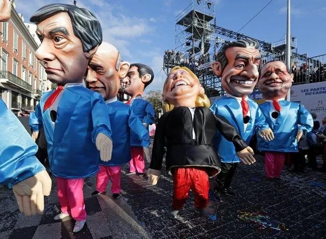 Fugures of former French Prim Minister Francois Fillon (L), member of The Republicans political party and 2017 presidential candidate of the French centre-right, French National Front leader Marine Le Pen (C) and former French President Nicolas Sarkozy (R) are paraded through the crowd during the Carnival parade of the 133rd carnival, the first major event since the city was attacked during Bastille Day celebrations last year in Nice, France, February 19, 2017. (Photo by Eric Gaillard/Reuters)
