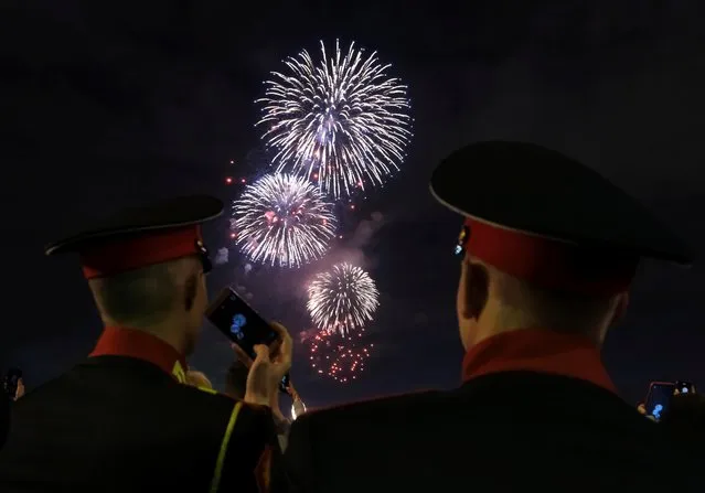 Cadets watch fireworks exploding in the sky during celebrations of the Victory Day, marking the anniversary of the victory over Nazi Germany in World War Two, in Moscow, Russia May 9, 2019. (Photo by Shamil Zhumatov/Reuters)