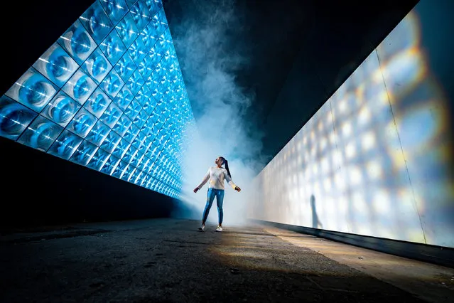 Law student at Plymouth University, Elysha Joseph, walks on November 15, 2021 through an art installation called Sola by the art collective Squidsoup, at Illuminate, the annual light art event at Royal William Yard in Plymouth, where the event is returning to showcase immersive digital installations. (Photo by Ben Birchall/PA Images via Getty Images)