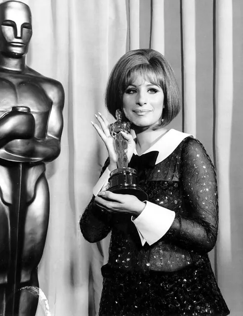 Barbra Streisand holds her “Oscar” after she was named co-winner of the Best Actress Award in the 41st Annual Academy Awards on April 14, 1969. Streisand and Katharine Hepburn made Academy history with the dual award. (Photo by Bettmann/Getty Images)