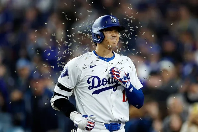Shohei Ohtani #17 of the Los Angeles Dodgers is showered with sunflower seeds by Teoscar Hernandez #37 after hitting a solo home run during the seventh inning against the San Francisco Giants at Dodger Stadium on April 3, 2024 in Los Angeles, California. The home run is Ohtani's first as a Dodger. (Photo by Kevork Djansezian/Getty Images)