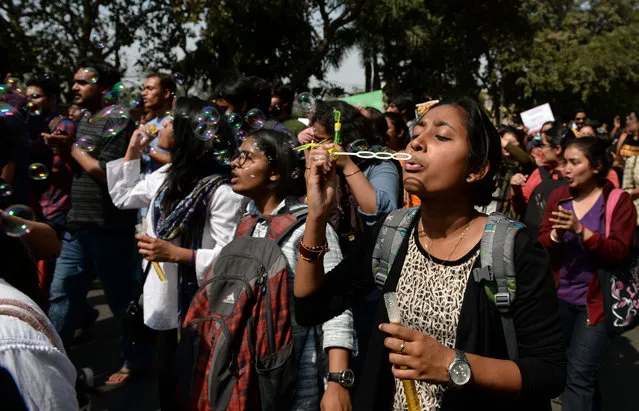 An Indian student blows bubbles as she joins others during a protest march outside Delhi University against the Akhil Bharatiya Vidyarthi Parishad (ABVP) students wing of Bharatiya Janata Party (BJP) in New Delhi on February 28, 2017, after it was accused of attacking students, lecturers and journalists in the campus on February 22. (Photo by Sajjad Hussain/AFP Photo)