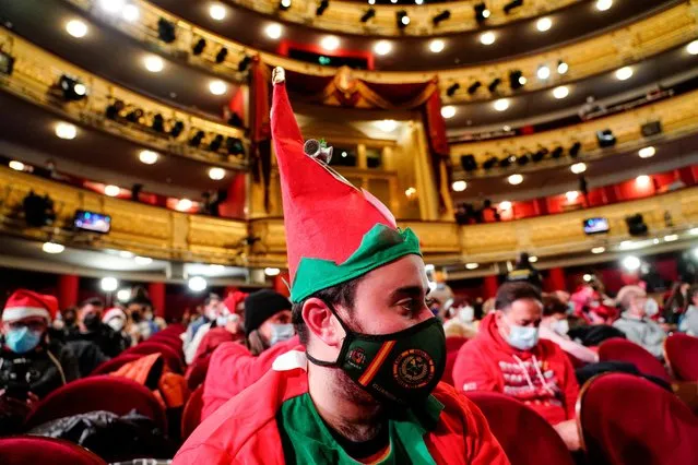 A man dressed in an elf costume looks on before the draw of Spain's traditional Christmas Lottery “El Gordo” (The Fat One) at the Royal Theatre, in Madrid, Spain, December 22, 2021. (Photo by Juan Medina/Reuters)