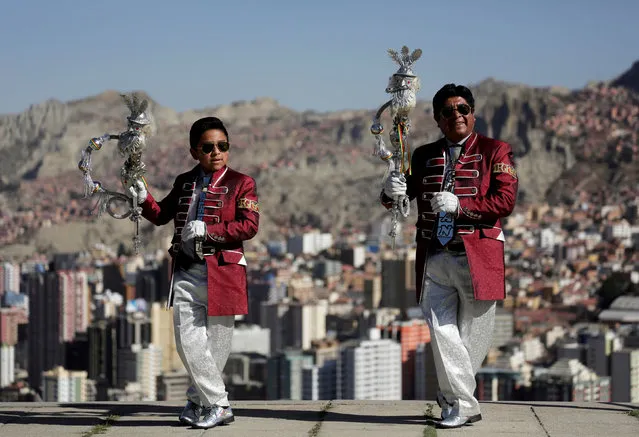 Santos Poma and his grandson Ariel pose for a photo before a parade in honor of “Senor del Gran Poder” (Lord of Great Power) in La Paz, Bolivia, June 6, 2019. (Photo by David Mercado/Reuters)