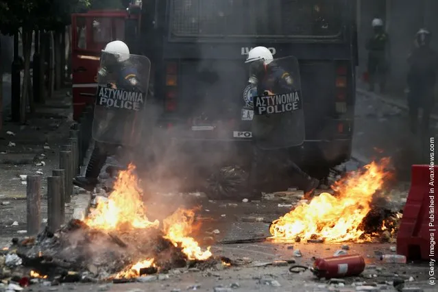 Demonstrators clashes with police during a protest against plans for new austerity measures in Athens, Greece
