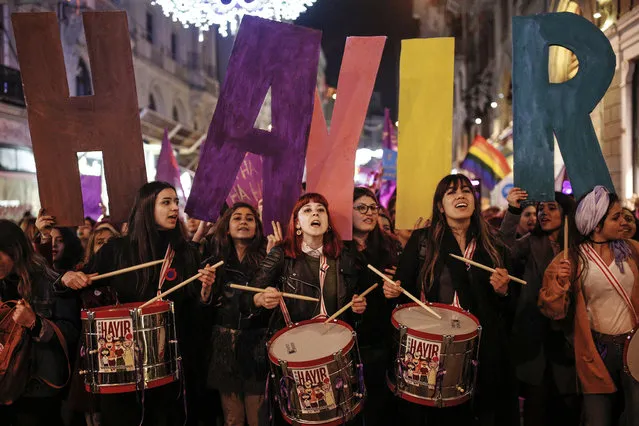 Women holding letters forming the word “NO” in Turkish, play drums and chant slogans during a protest marking the International Women's Day, in central Istanbul's Istiklal Avenue, the main shopping road of Istanbul, Wednesday, March 8, 2017. (Photo by Emrah Gurel/AP Photo)