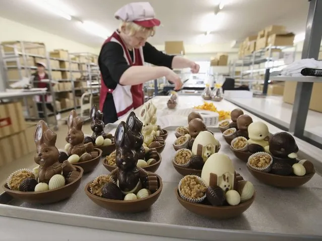 Employee Doreen Krohe packs chocolate Easter bunnies and eggs at the production facility at Confiserie Felicitas chocolates maker in Hornow. Easter is among the busiest times of year for the chocolatier, which produces Easter bunnies and eggs in a wide variety of sizes and styles. (Photo by Sean Gallup/Getty Images)