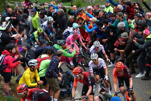 Pink jersey Team UAE's Slovenian rider Tadej Pogacar (C) climbs the Mortirolo section surrounded by fans during the 15th stage of the 107th Giro d'Italia cycling race, 222km between Manerba del Garda and Mottolino on May 19, 2024. (Photo by Luca Bettini/AFP Photo)