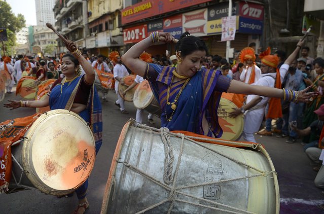 Indian women dressed in traditional attire play drums as they take part in a procession celebrating “Gudhi Padwa” or the Maharashtrian New Year in Mumbai on March 28, 2017. (Photo by Punit Paranjpe/AFP Photo)