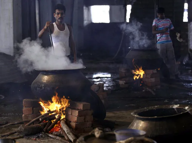 Workers prepare food in a community kitchen at a Muslim shrine in Kolkata August 4, 2010. (Photo by Rupak De Chowdhuri/Reuters)
