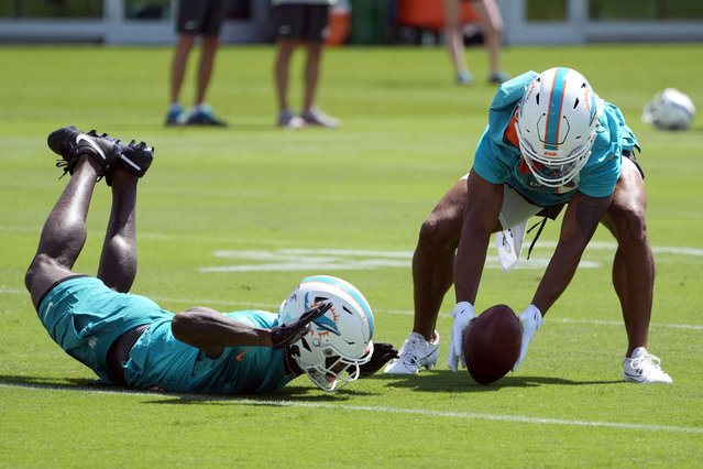 Miami Dolphins Elijah Campbell, right, picks up the ball as Siran Neal is late with the catch during NFL football practice at the team's training facility, Wednesday, June 5, 2024, in Miami Gardens, Fla. (Photo by Marta Lavandier/AP Photo)
