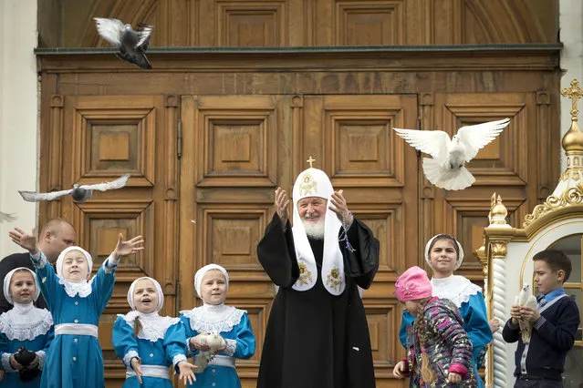 Russian Orthodox Church Patriarch Kirill, center, releases birds at Annunciation Cathedral in the Moscow's Kremlin in Moscow, Russia, Friday, April 7, 2017, to mark the Russian Orthodox holiday of the Annunciation. (Photo by Alexander Zemlianichenko/AP Photo)