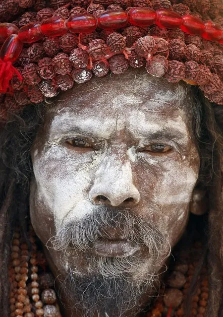 A Naga sadhu, or naked Hindu holy man, sits inside his tent during the month long Kumbh festival at Ujjain in the central Indian state of Madhya Pradesh, Friday, May 13, 2016. Thousands of pilgrims have gathered in this holy city for the ritual dip in the River Shipra, which takes place once every 12 years. (Photo by Rajanish Kakade/AP Photo)