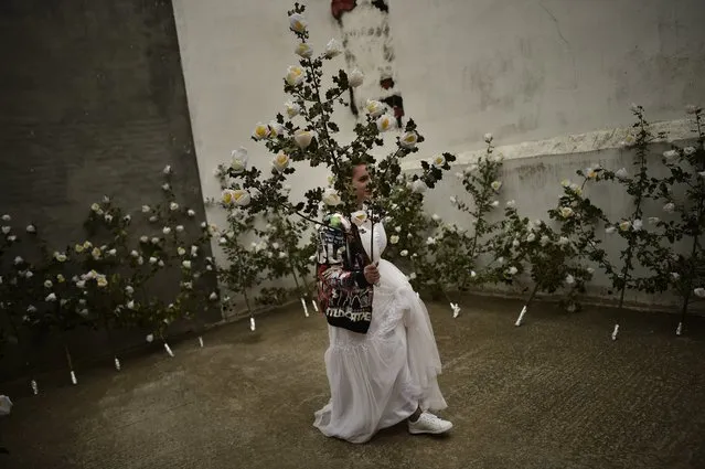 A participant dressed in bridal white surrounded by flowers, takes part in the pilgrimage “The Hundred Maidens”, in Sorzano, northern Spain, Sunday, May 15, 2016. According to ancient traditions, the pilgrimage “The Hundred Maidens” is in honor of the spring season and the fertility of women, today is also in honor of the Virgin Mary. (Photo by Alvaro Barrientos/AP Photo)