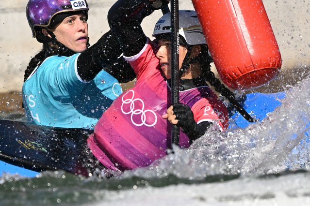 Australia's Noemie Fox (R) competes against Britain's Kimberley Woods in the women's kayak cross final of the canoe slalom competition at Vaires-sur-Marne Nautical Stadium in Vaires-sur-Marne during the Paris 2024 Olympic Games on August 5, 2024. (Photo by Bertrand Guay/AFP Photo)